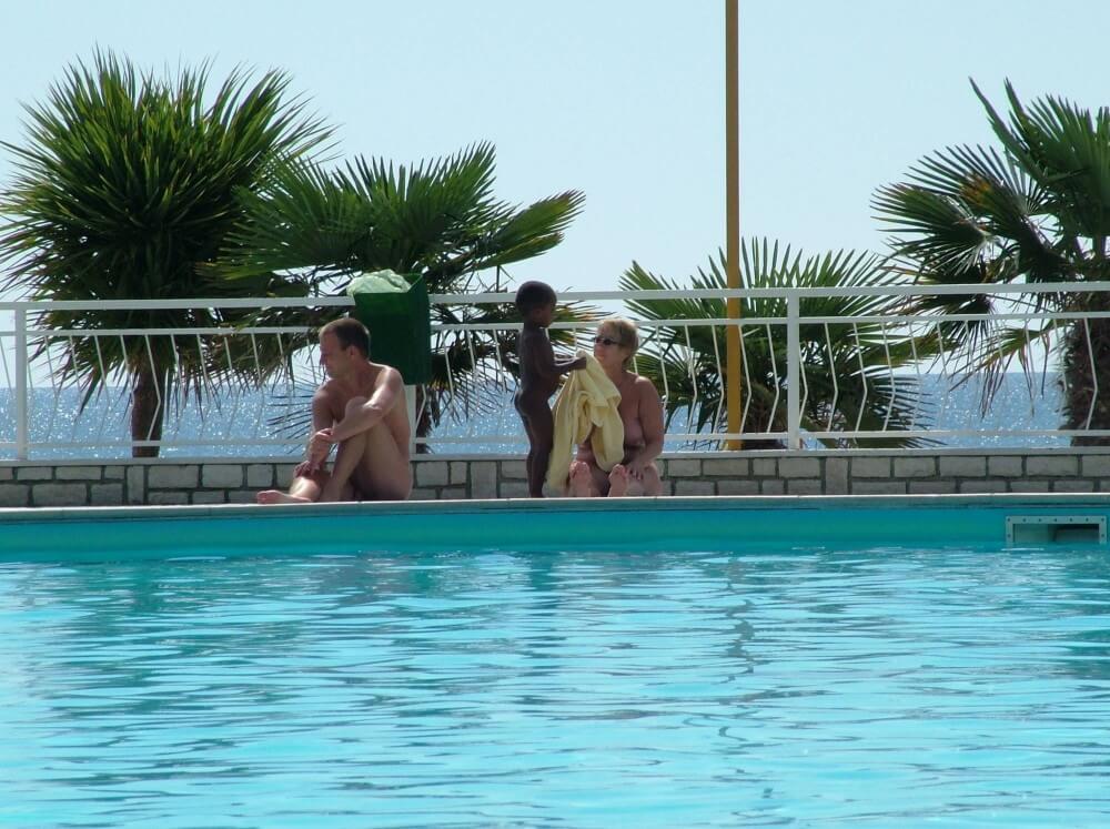 Photo of naturists in an outdoor pool - Through naturism, people seek the opportunity to feel free and in harmony